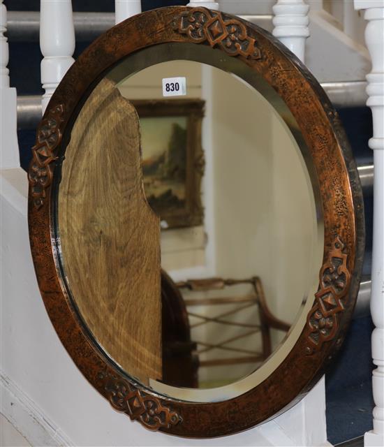 A circular hammered copper framed wall mirror, with bevelled plate W.53cm